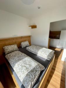 two beds sitting in a room with at Hotel Lercher in Sankt Veit im Pongau