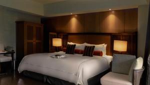 Rúm í herbergi á Grand View Resort Beitou