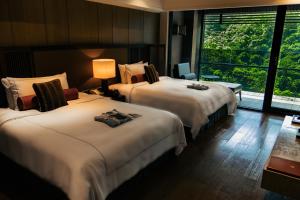 Rúm í herbergi á Grand View Resort Beitou