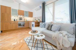 a living room with a couch and a table at Venus Apartments - Skylit - Deluxe Loft with Skylight in Budapest