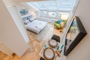 an overhead view of a bedroom with a bed and a table at Venus Apartments - Skylit - Deluxe Loft with Skylight in Budapest