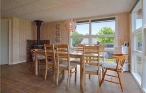 a dining room with a table and chairs and a fireplace at Holiday Home Hemmet With Hot Tub Vii in Hemmet +8 photos