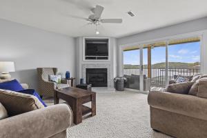 a living room with two couches and a fireplace at Quietside in Camdenton