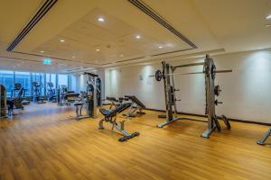 a gym with several tread machines in a room at Dar Alsalam - Stunning Apartment in Afnan 2 With Balcony in Dubai