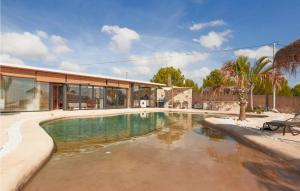 a swimming pool in front of a house at Stunning Home In Murcia With Swimming Pool in Murcia