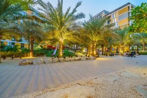 a park with palm trees and a skate park at Dar Alsalam - Modern Apartment With Stunning Views in Dania 3 in Dubai