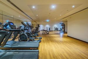 a gym with treadmills and ellipticals in a room at Dar Alsalam - Modern Apartment With Stunning Views in Dania 3 in Dubai