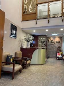 a waiting room with chairs and a hair salon at Mia Hotel in Ho Chi Minh City