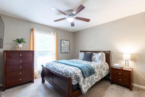 a bedroom with a bed and a ceiling fan at Allwood Cottage 2 in North Little Rock