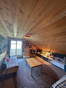 a living room with a couch and a table at Cache-Cache MOUNTAIN & QUIET chalet 10 pers in Veysonnaz