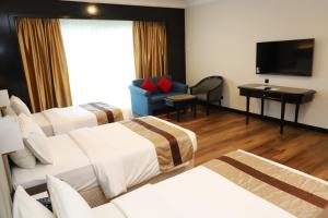 Voodi või voodid majutusasutuse Grand Darul Makmur Hotel Kuantan toas