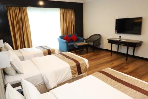 Voodi või voodid majutusasutuse Grand Darul Makmur Hotel Kuantan toas