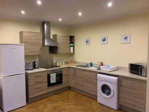 a kitchen with a washing machine and a washer at The old post office in Golspie