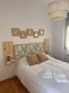 a bedroom with a white bed with two towels on it at Casa La Chicuela in Lapeza