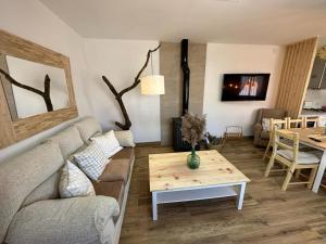 a living room with a couch and a table at Casa La Chicuela in Lapeza