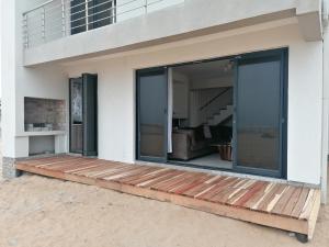 a house with sliding glass doors on a deck at 074DB on Dune Lark in Walvis Bay