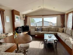 a living room with a couch and a table at Free Spirit - Landscove Holiday Park in Brixham in Brixham