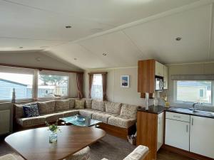 a living room with a couch and a table at Free Spirit - Landscove Holiday Park in Brixham in Brixham