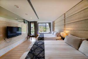 Postel nebo postele na pokoji v ubytování Tai-Yi Red Maple Resort + 37 fotografií