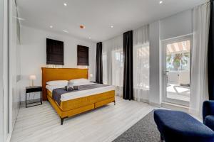 a bedroom with a bed and a large window at BAL Apartments Adults Only in Arona