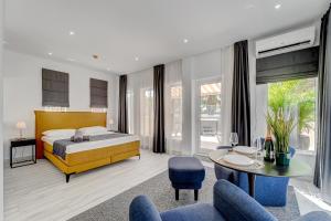 a bedroom with a bed and a table and chairs at BAL Apartments Adults Only in Arona +37 photos