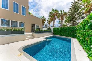 a swimming pool in the backyard of a house at BAL Apartments Adults Only in Arona
