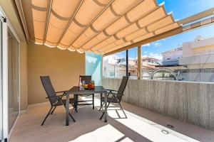 a dining room with a table and chairs on a balcony at BAL Apartments Adults Only in Arona