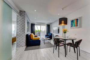 a living room with a table and a dining room at BAL Apartments Adults Only in Arona
