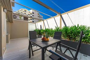 a table and chairs on the balcony of a building at BAL Apartments Adults Only in Arona