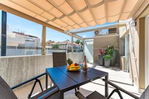 a table with a bowl of fruit on a balcony at BAL Apartments Adults Only in Arona
