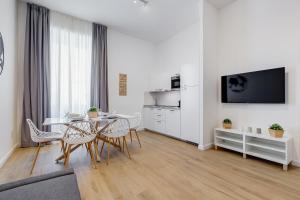 a white living room with a table and chairs at Colonna Luxury Apartment in Rome