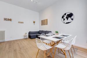a dining room with a table and chairs and a couch at Colonna Luxury Apartment in Rome