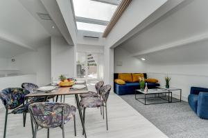 a dining room with a table and chairs and a couch at BAL Apartments Adults Only in Arona