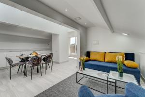 a living room with a blue couch and a table at BAL Apartments Adults Only in Arona