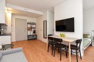 a kitchen and a living room with a table and chairs at Grey Hill in Juodkrantė +5 photos