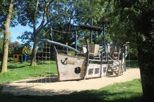 a playground with a slide in a park at Ferienhaus Strandnah - Wohnung 1 in Otterndorf