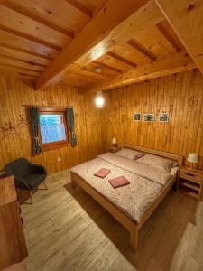 a bedroom with a bed in a wooden cabin at Chata pod Kyčerou in Terchová