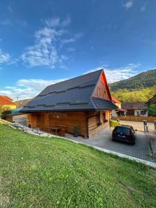 a barn with a car parked in front of it at Chata pod Kyčerou in Terchová