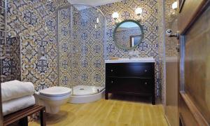 a bathroom with a toilet and a sink and a mirror at Dzuku apartment 11 in Vilnius +6 photos