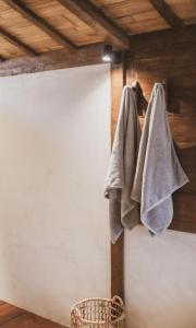 a towel hanging on a wall next to a basket at Kalyana Villa Gili Air in Gili Air