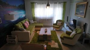 a living room with a couch and chairs and a table at Center Una Apartment in Bihać