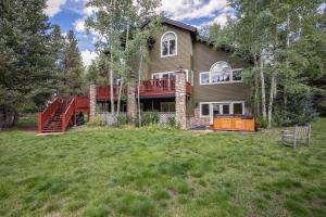 a large house with a deck and a yard at Brooks Hill Lodge in Breckenridge