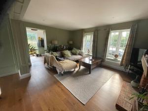 a living room with a couch and a table at Hall Farm Cottage, Barham in Ipswich