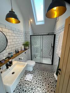 a bathroom with a shower and a tub and a toilet at Hall Farm Cottage, Barham in Ipswich