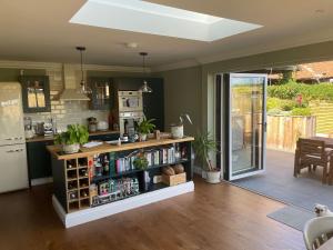 a kitchen with a book shelf and a refrigerator at Hall Farm Cottage, Barham in Ipswich
