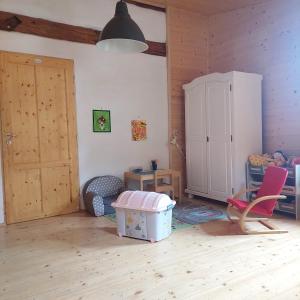 a room with a table and chairs and a cabinet at Apartmány U Tří Sluncí in Hroubovice