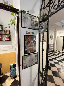 a refrigerator in a room with a checkered floor at Hostel A2C in Seville