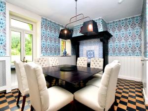 a dining room with a table and chairs at Luxurious castle with hot tub in the Belgian in Jamoigne