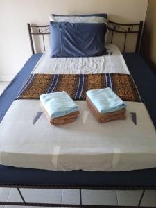 - un lit avec 2 serviettes dans l'établissement Mersing Chalet Teluk Sisek, 