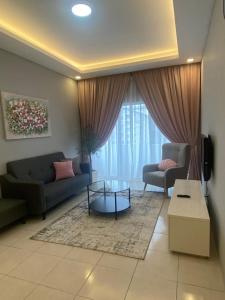 a living room with a couch and a table at Biella Homestay Apartment for Muslim in Tanah Rata